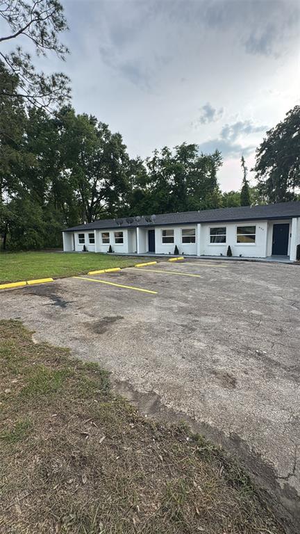 836 Southwest 64th Terrace, Unit A Gainesville, FL 32607 - Photo 13 of 13 a view of a house next to a big yard with large trees