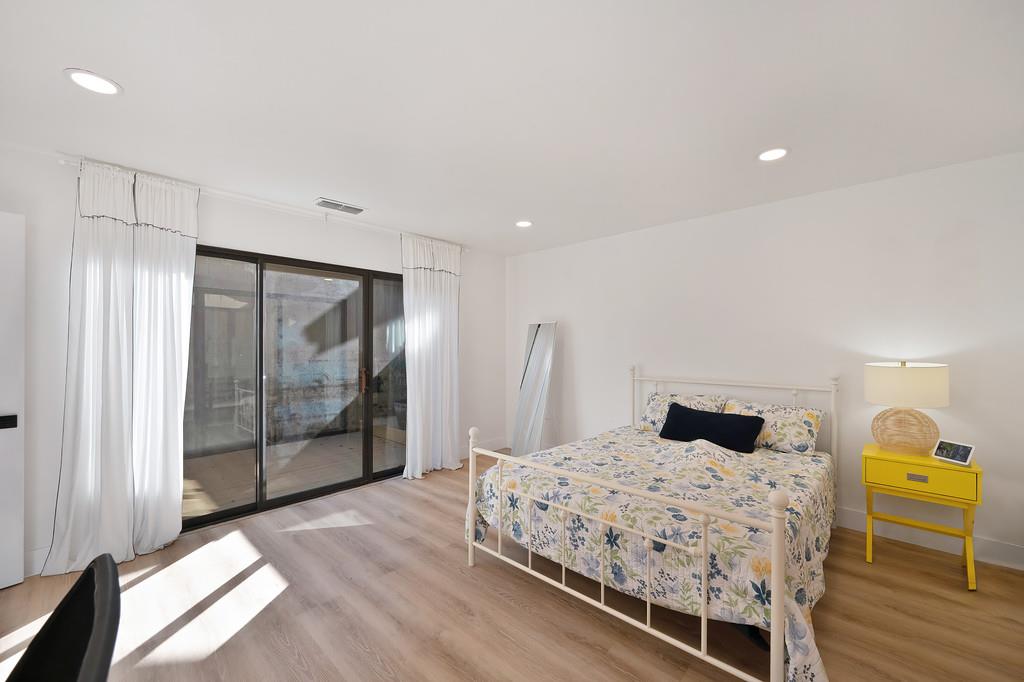 224 East Ranch Road Sacramento, CA 95825 - Photo 21 of 65 a bedroom with a bed and wooden floor