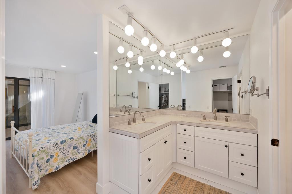 224 East Ranch Road Sacramento, CA 95825 - Photo 23 of 65 a en suite bathroom with double sink and a mirror