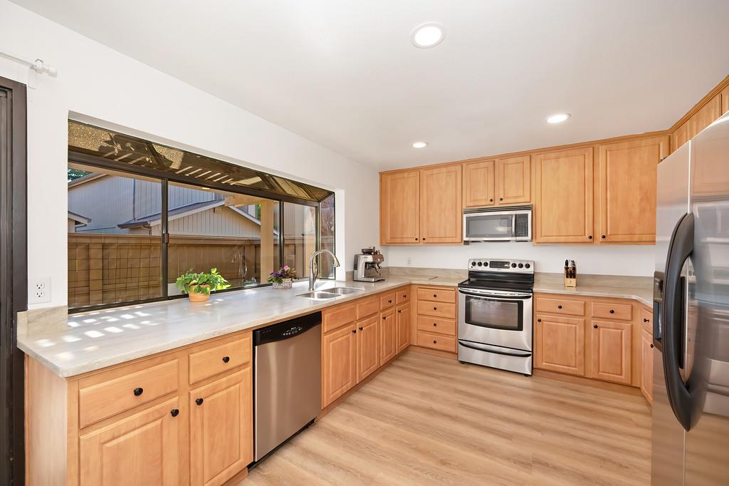 224 East Ranch Road Sacramento, CA 95825 - Photo 36 of 65 a kitchen with granite countertop a sink stainless steel appliances and counter space
