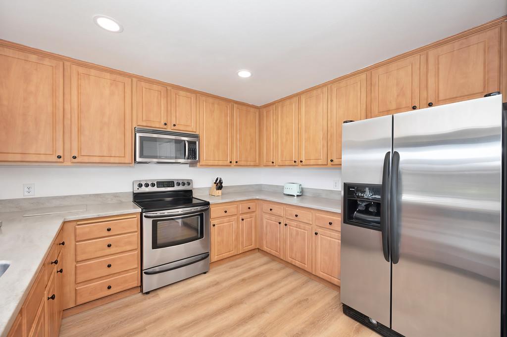 224 East Ranch Road Sacramento, CA 95825 - Photo 37 of 65 a kitchen with granite countertop white cabinets and stainless steel appliances
