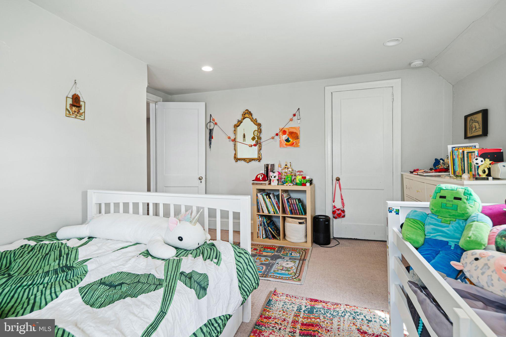 721 Rugby Road Bryn Mawr, PA 19010 - Photo 25 of 38 a bedroom with furniture a baby bed a couch and a baby crib