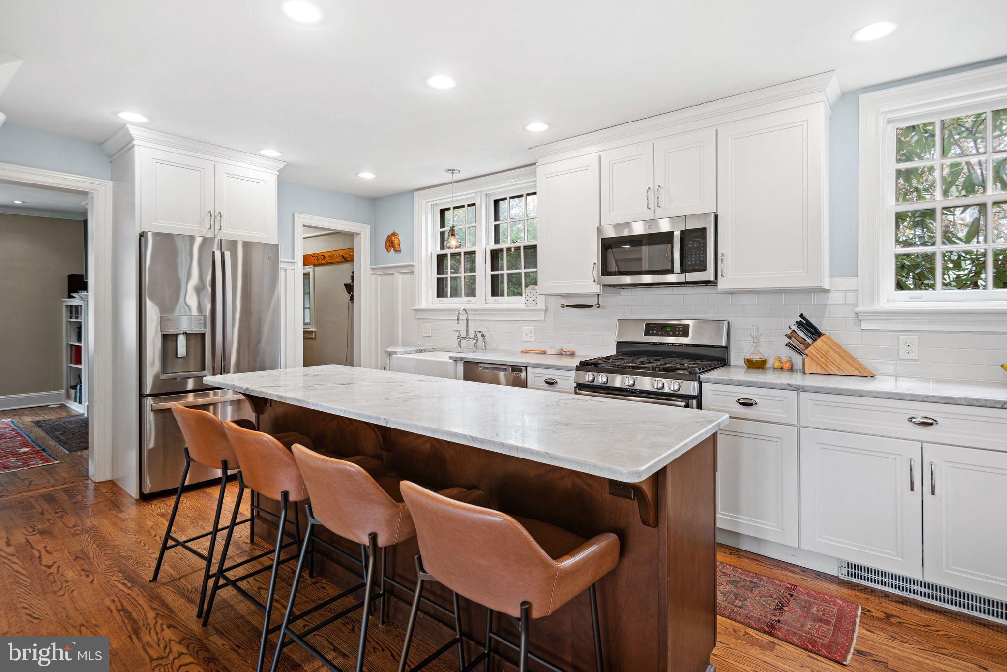 721 Rugby Road Bryn Mawr, PA 19010 - Photo 9 of 38 a kitchen with stainless steel appliances granite countertop a stove a sink a refrigerator a dining table and chairs