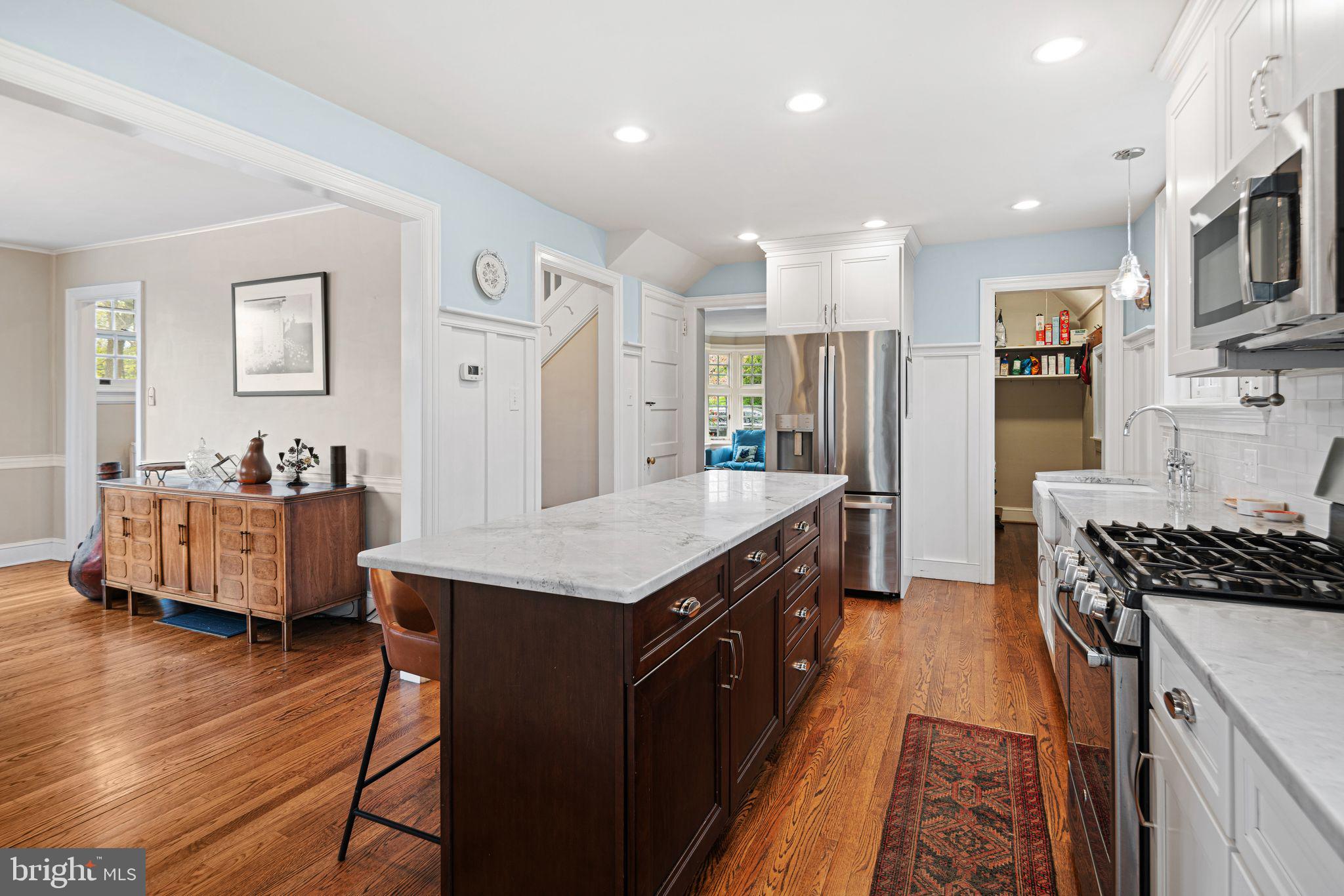 721 Rugby Road Bryn Mawr, PA 19010 - Photo 10 of 38 a kitchen with stainless steel appliances granite countertop a refrigerator a stove a sink dishwasher and a dining table with wooden floor