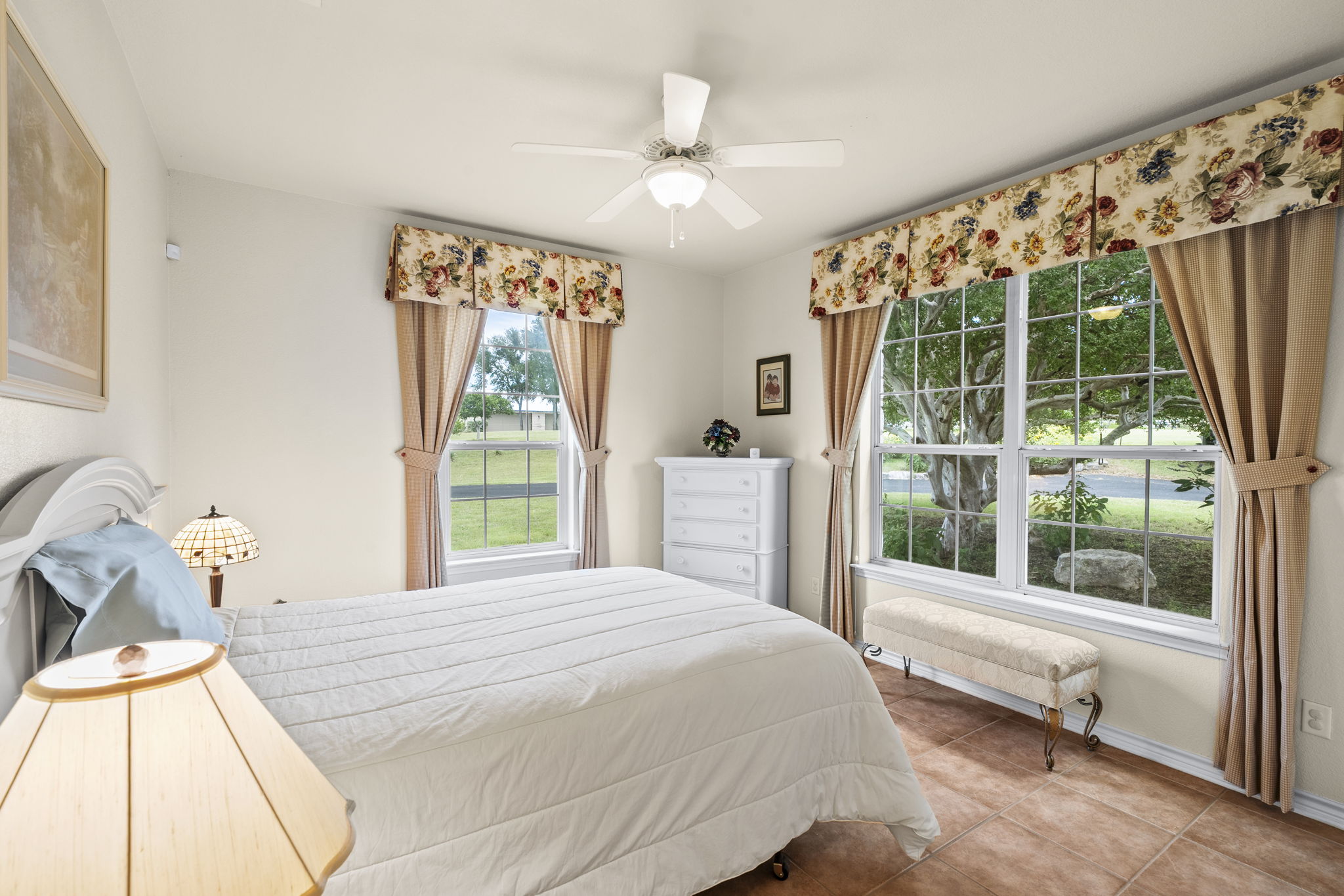 1427 River Ridge Ranch Road Killeen, TX 76549 - Photo 14 of 40 Enjoy comfort in this naturally illuminated bedroom featuring tile flooring and a ceiling fan.