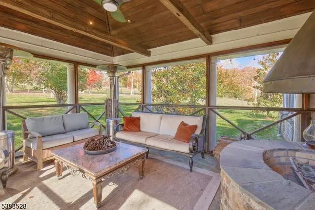 a living room with patio furniture and a large window
