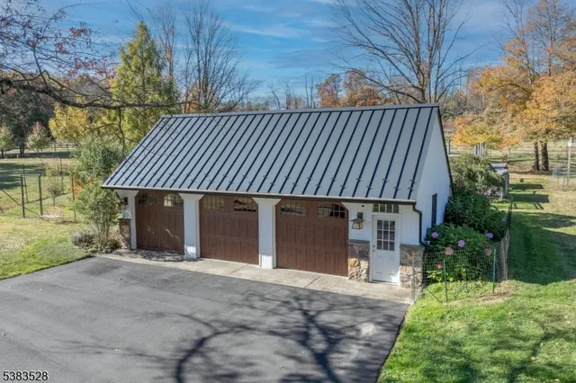 a front view of a house with a yard and potted plants