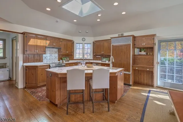 a large kitchen with a table and chairs