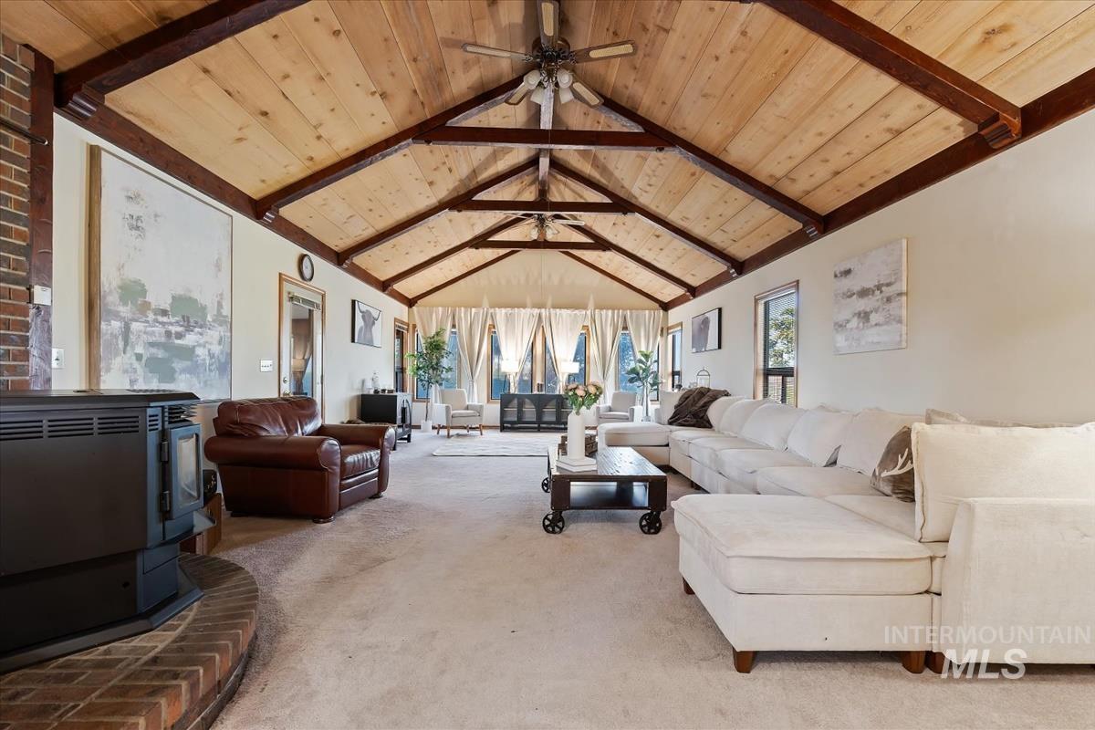 8275 Washoe Road Fruitland, ID 83619 - Photo 3 of 43 Vaulted wood-paneled ceiling with exposed beams, brick-clad hearth, and light-colored wall finishes