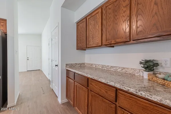 a kitchen with granite countertop cabinets washer and dryer
