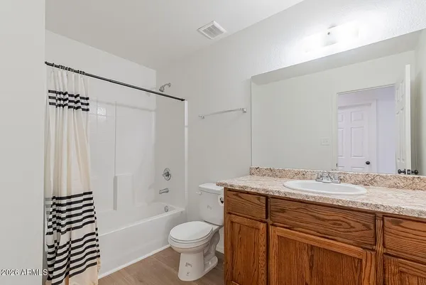 a bathroom with a sink toilet a mirror and shower