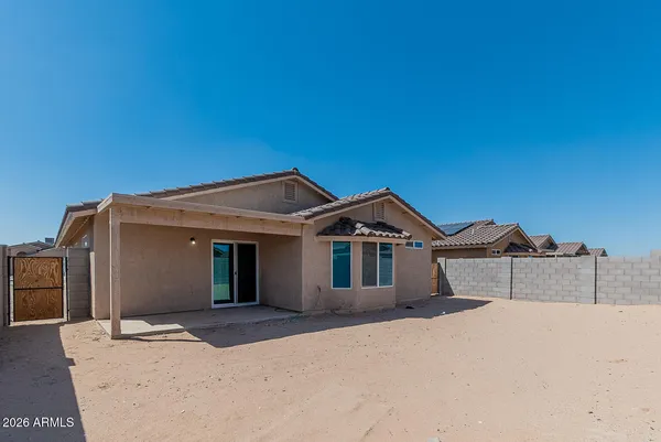 a view of a house with a yard in the background