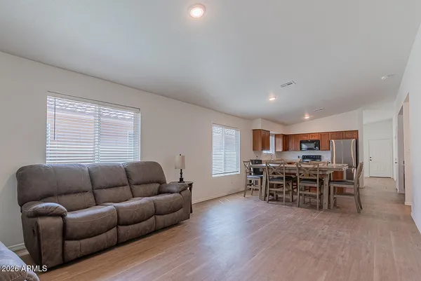 a living room with furniture and a wooden floor