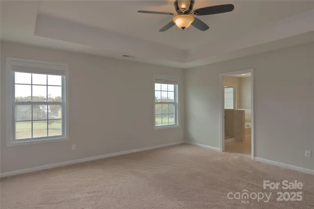 a bathroom with a granite countertop sink a large mirror and a bathtub with shower
