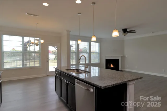 a kitchen with a sink and chandelier