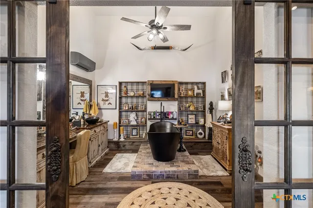 a living room with furniture a chandelier and a rug