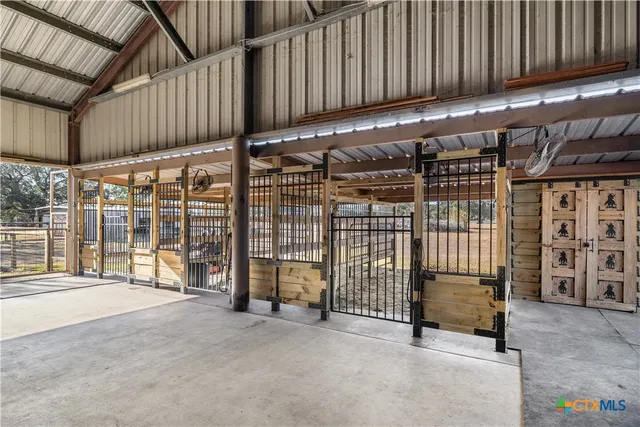 a view of an empty room with wooden fence