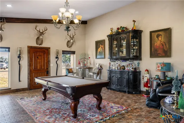 a room with a table chairs and a chandelier