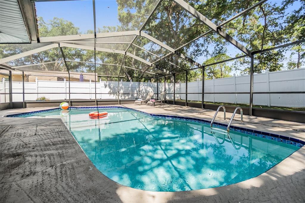 1 Fernery Lane Safety Harbor, FL 34695 - Photo 13 of 44 a view of a swimming pool with a porch