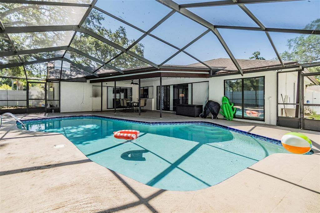 1 Fernery Lane Safety Harbor, FL 34695 - Photo 14 of 44 a house with swimming pool in front of it