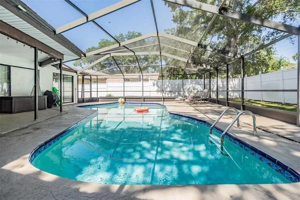 a view of a swimming pool with a patio