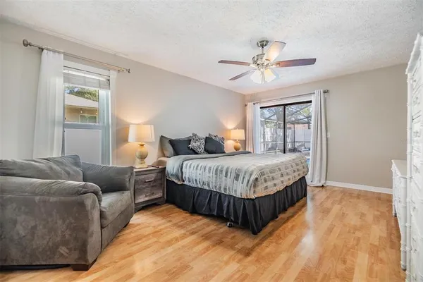a bedroom with a bed couch and window