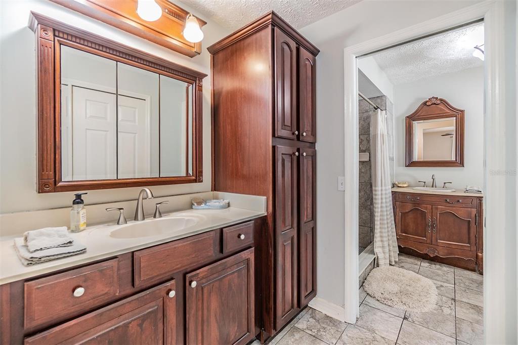 1 Fernery Lane Safety Harbor, FL 34695 - Photo 20 of 44 a bathroom with a granite countertop sink mirror and