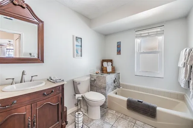 a bathroom with a toilet a sink and a bathtub
