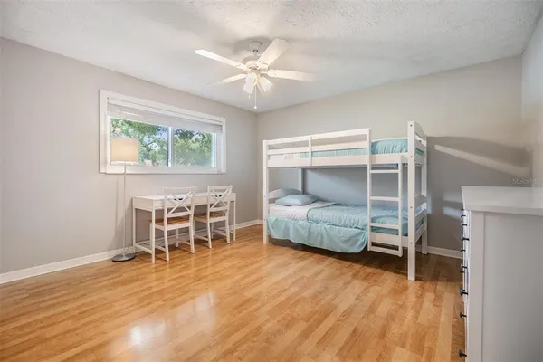 a bedroom with furniture and a wooden floor