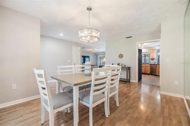 a view of a dining room with furniture wooden floor and chandelier