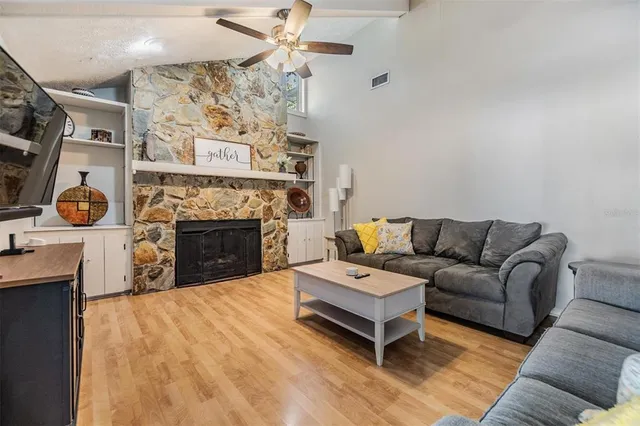 a living room with furniture and a fireplace