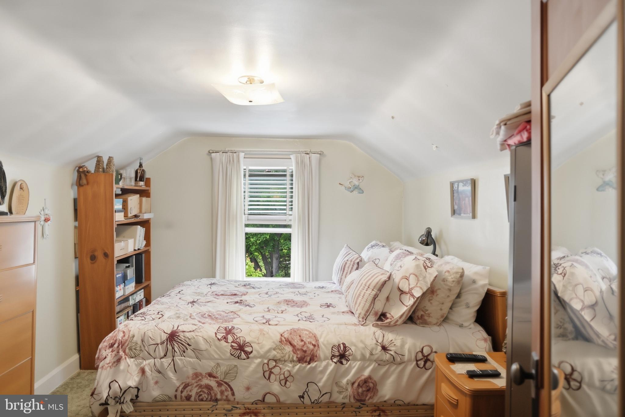 378 Spruce Street Thomas, WV 26292 - Photo 19 of 30 a bedroom with a bed and a chandelier