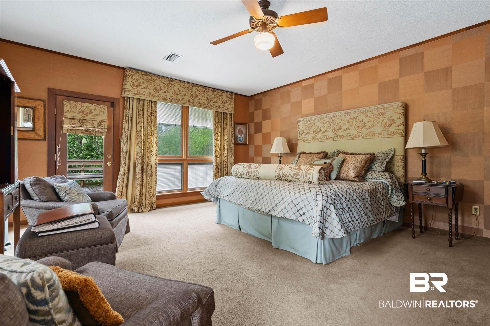 3500 Venetia Road Mobile, AL 36605 - Photo 17 of 56 Spacious bedroom featuring patterned wall treatments, light brown carpet flooring, an exterior door leading to a balcony, a large window, and an overhead ceiling fan with light fixture