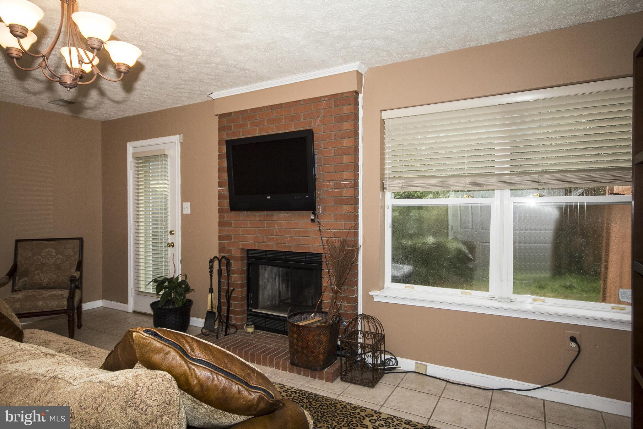 5243 Downing Road Baltimore, MD 21212 - Photo 6 of 30 Family Room w/wood burning frpl & flat screen TV