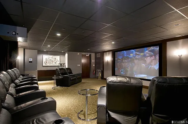 a media room with lots of chairs and a projector screen