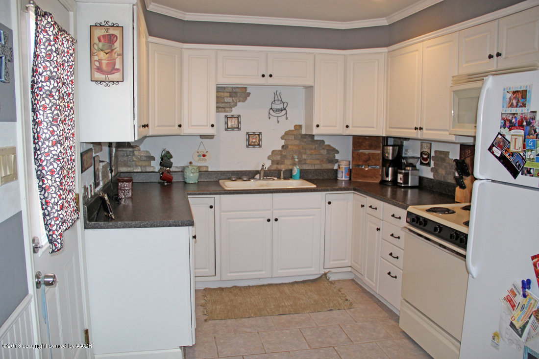 5016 South Bonham Street Amarillo, TX 79110 - Photo 2 of 31 a kitchen with white cabinets and sink