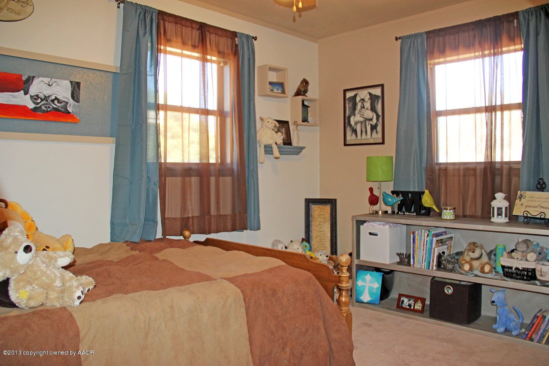5016 South Bonham Street Amarillo, TX 79110 - Photo 17 of 31 a bedroom with a bed and a window