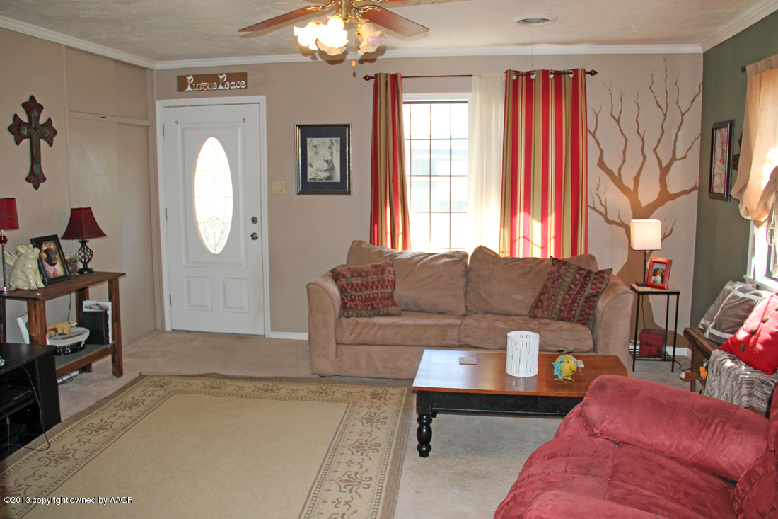 5016 South Bonham Street Amarillo, TX 79110 - Photo 3 of 31 a living room with furniture a window and a chandelier