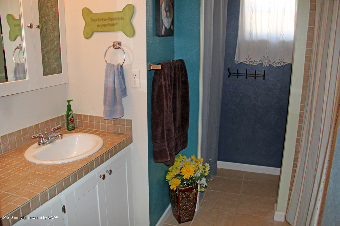 5016 South Bonham Street Amarillo, TX 79110 - Photo 21 of 31 a bathroom with a sink and a mirror
