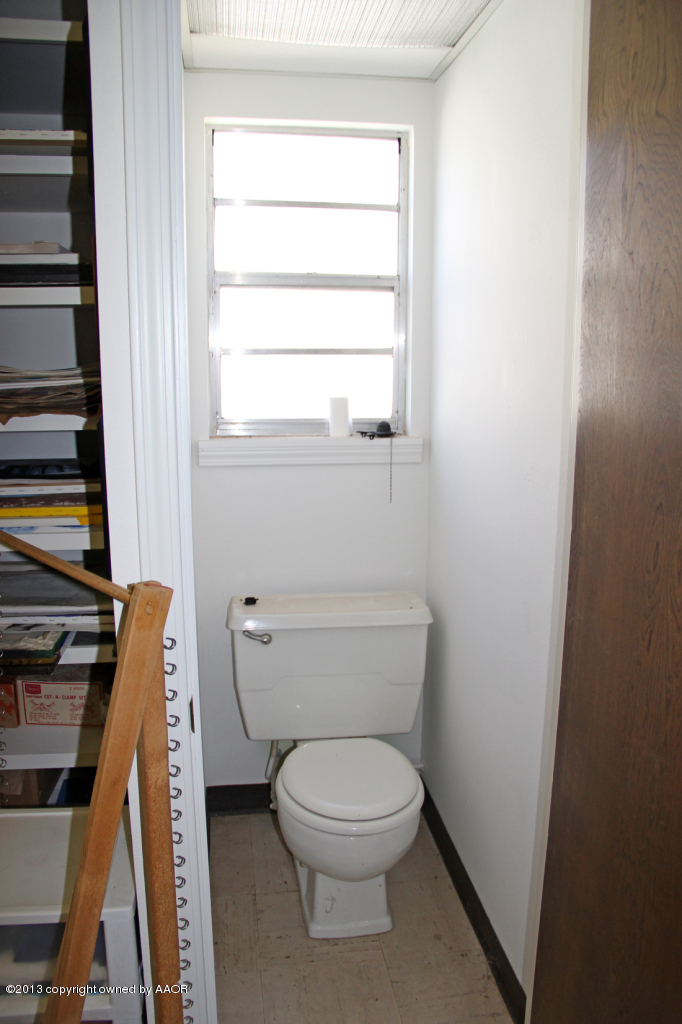 5016 South Bonham Street Amarillo, TX 79110 - Photo 31 of 31 a white toilet sitting next to a window