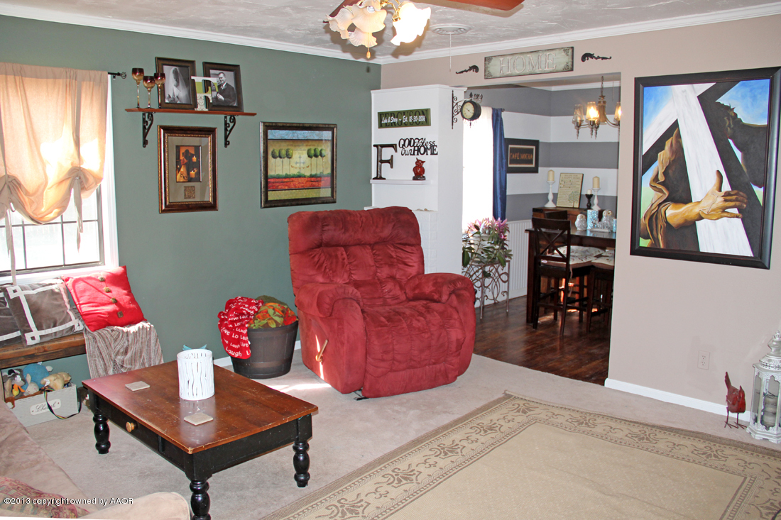 5016 South Bonham Street Amarillo, TX 79110 - Photo 5 of 31 a living room with furniture and a chandelier