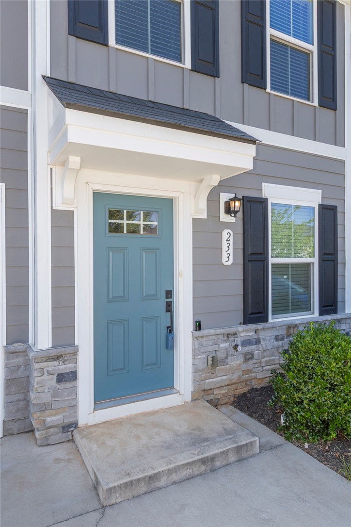 233 Scenic Road Anderson, SC 29621 - Photo 3 of 50 A welcoming turquoise entry door with a decorative overhang creates an inviting approach.