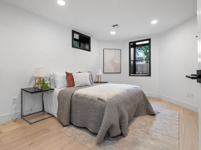 a bedroom with a bed and window