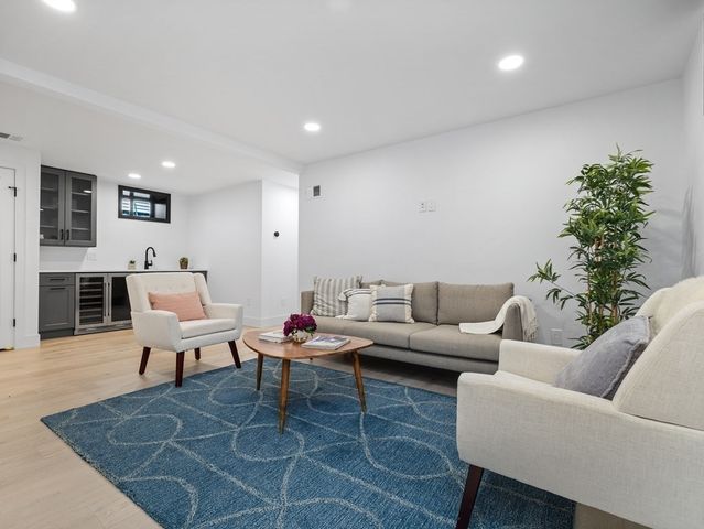 a living room with furniture potted plant and a fireplace