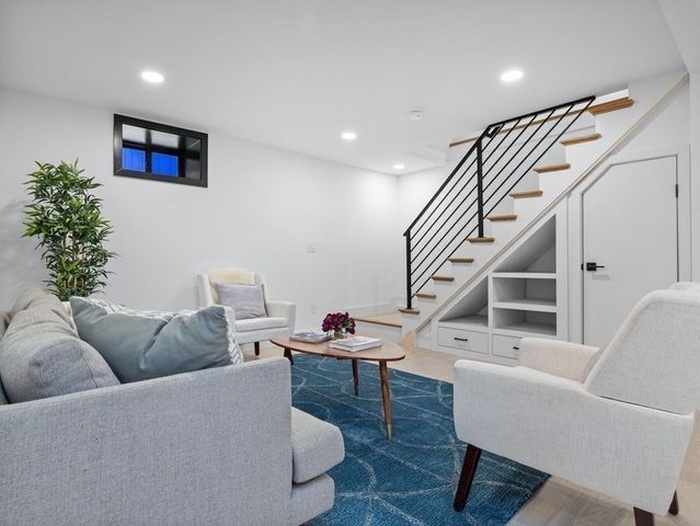a living room with furniture and a potted plant