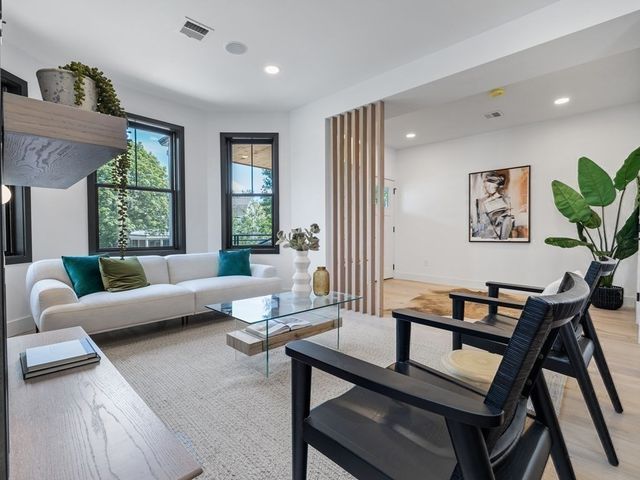 a living room with furniture and a potted plant