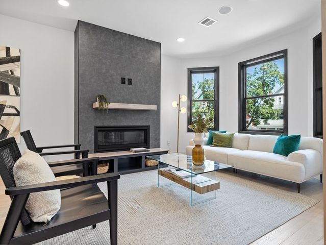 a living room with furniture a window and a fireplace