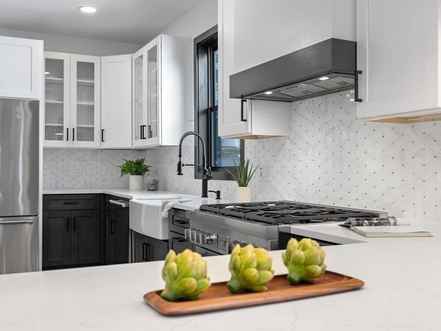 a kitchen with a stove and cabinets