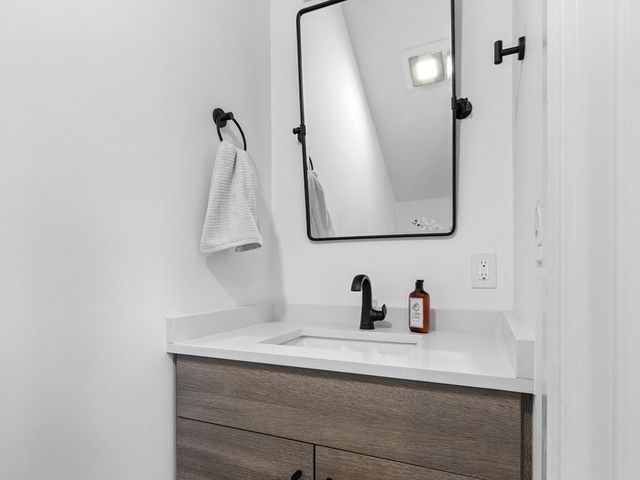 a bathroom with a sink and mirror