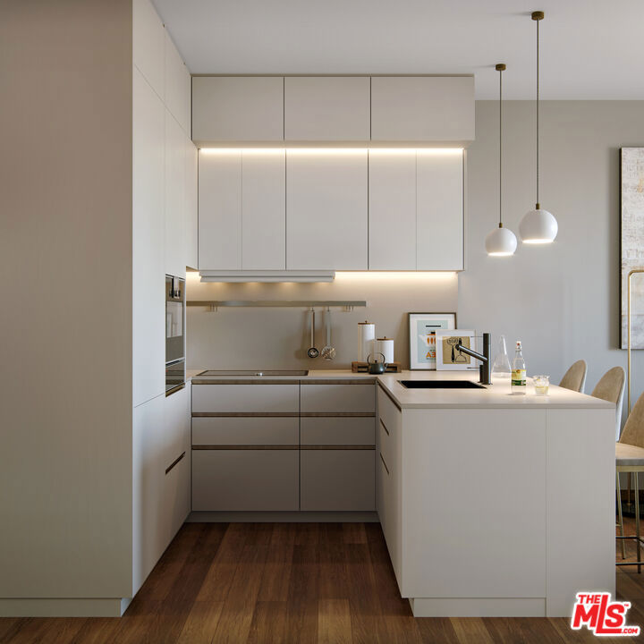 5 Pindou & Kithnou Athens Greece undefined, undefined 0 - Photo 8 of 14 a kitchen with kitchen island a stove a sink and a refrigerator with wooden floor